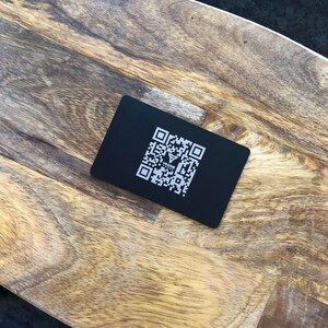Minimalist modern business card with custom QR code and branding.