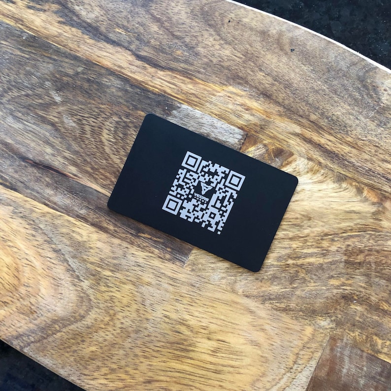 Minimalist modern business card with custom QR code and branding.
