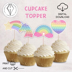 May include: Four cupcakes with white frosting and gold foil wrappers are topped with colorful cupcake toppers. The toppers feature a star, unicorn, rainbow, and heart design with a bubble-pop theme. Text on the image reads "Cupcake Topper" and "Digital Download".