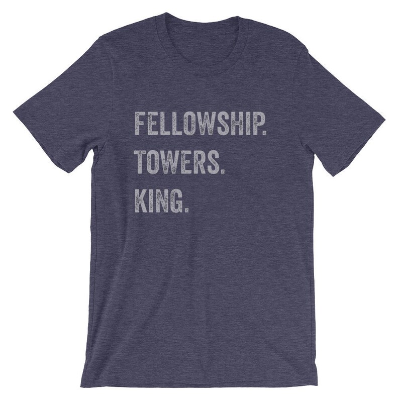 May include: A navy blue t-shirt with the text "FELLOWSHIP. TOWERS. KING." printed in white.