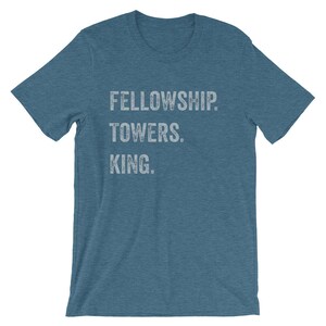 May include: A blue t-shirt with the text "FELLOWSHIP TOWERS. KING." printed in white.