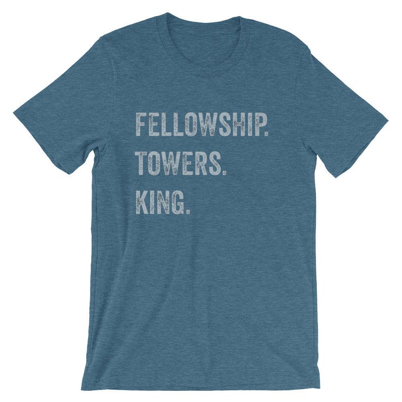 May include: A blue t-shirt with the text "FELLOWSHIP TOWERS. KING." printed in white.