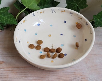 Ceramic cat bowl with blue and orange dots, stripes and fish, handpainted design. Handmade pottery feeder cats gift