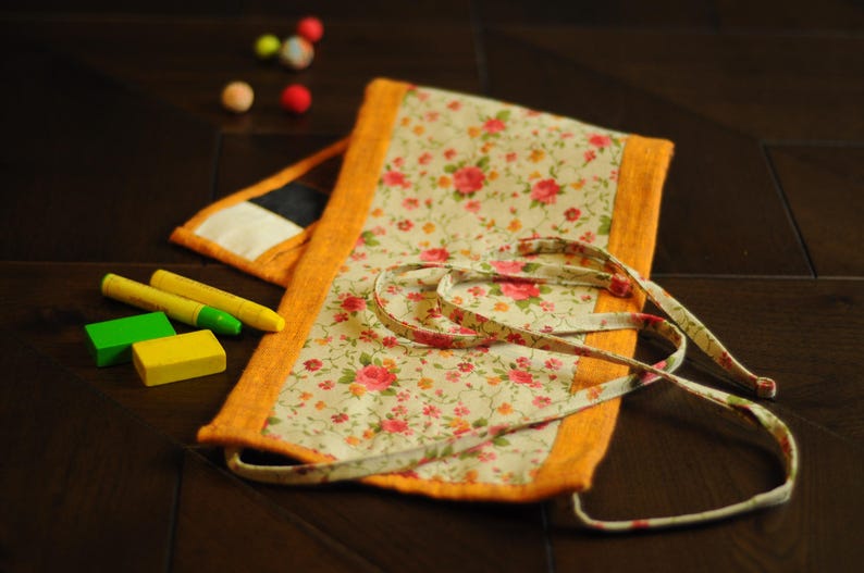 May include: A floral fabric pouch with a yellow trim and a white background. The pouch has a drawstring closure and is perfect for storing small items.