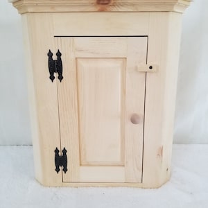 Unfinished Small Wall Corner Cabinet. Measures: 18 3/4" x 11 1/4" x 22" Tall.