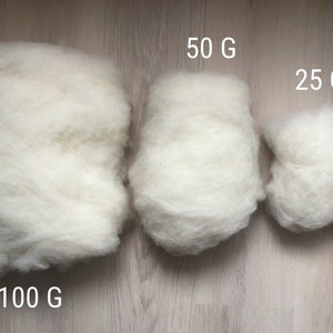 May include: Three white fluffy balls of wool, labeled 100 G, 50 G, and 25 G, showing the different sizes available.