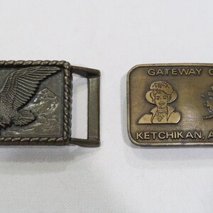 2 Vintage brass belt buckles-one with American eagle and the other is Gateway Club, Ketchikan, Alaska