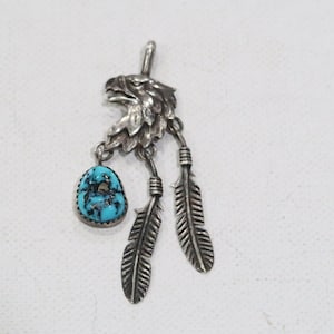 Navajo sterling eagle pendant with turquoise and feathers
