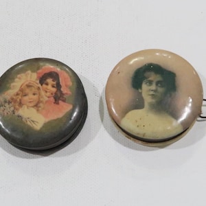 Antique tape measure lot, advertising tape measure and another old tape measure w vintage paintings