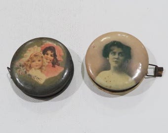 Antique tape measure lot, advertising tape measure and another old tape measure w vintage paintings