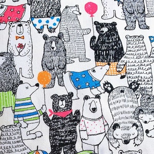 May include: White fabric with a repeating pattern of black and white bears wearing different outfits and holding various objects, including umbrellas, balloons, and fish. The bears are all smiling and appear to be having fun.