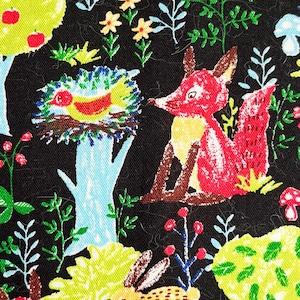 May include: A black fabric with a colorful woodland pattern. The pattern includes trees, birds, foxes, rabbits, mushrooms, and owls. The fabric is perfect for crafting projects like quilts, pillows, and bags.