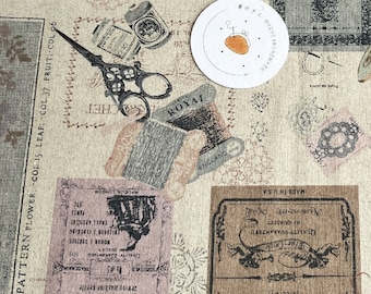 May include: A beige fabric with a repeating pattern of vintage-style labels and illustrations. The labels feature text such as "Blue Castle", "Sewing Machine", "Floral Pattern", and "Royal". The illustrations include scissors, spools of thread, and other sewing-related items.