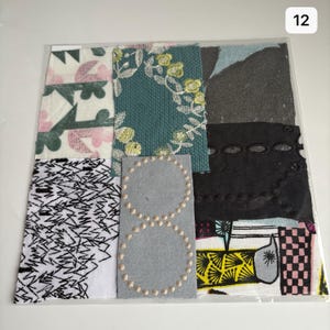 May include: A collage of fabric scraps in various patterns and colors, including black, white, pink, green, and blue. The fabric scraps are arranged in a grid pattern and are sewn together. The collage is framed with a white border.