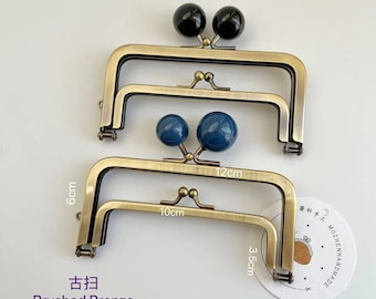 May include: Brushed bronze purse clasps with black and blue spherical closures. The clasps are 10 cm and 12 cm wide, and 6 cm and 3.5 cm high. The text "Brushed Bronze" and Chinese characters are visible.