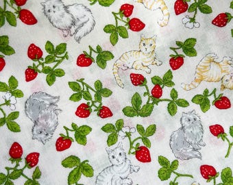 May include: White fabric featuring a repeating pattern of red strawberries, green leaves, and cartoon cats. The cats are in grey and orange, creating a playful design. The fabric is suitable for various craft projects.