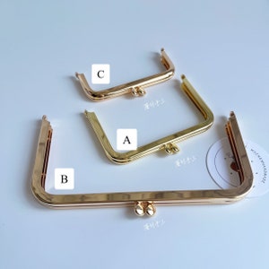 May include: Three gold-toned metal purse frames of different sizes. The frames are all rectangular with rounded corners and have two small metal balls on the bottom. The frames are labeled A, B, and C.