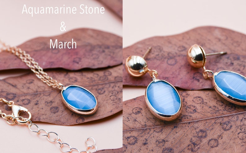 May include: A gold necklace and earrings set with oval-shaped aquamarine stones. The stones are a light blue color and are set in gold.