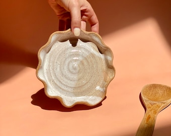 Handmade ceramic spoon rest. Wavy rim w/ raw speckled stoneware, glazed in splashes of white. Great housewarming gift for a new home.