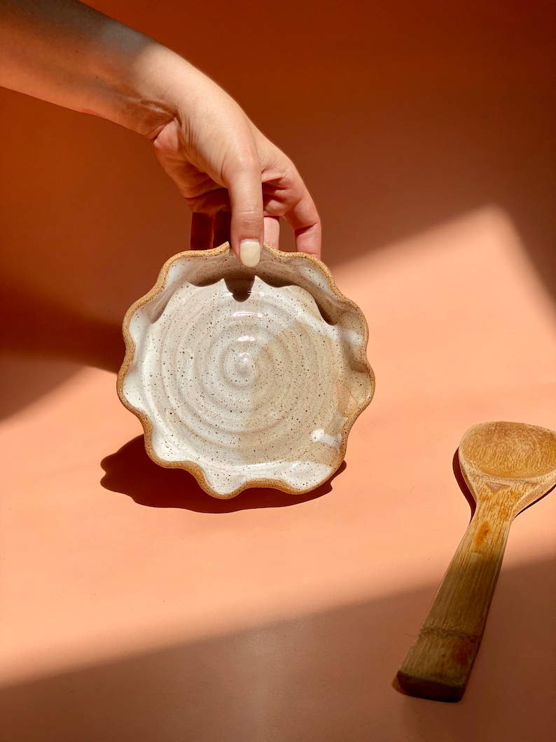 Handmade ceramic spoon rest. Wavy rim w/ raw speckled stoneware, glazed in splashes of white. Great housewarming gift for a new home.