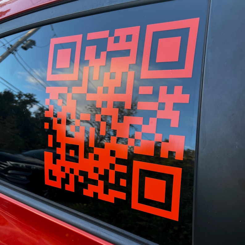 A Large orange decal on a tinted window.