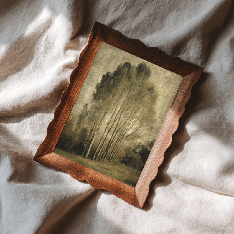 Peut inclure: Un cadre photo rectangulaire en bois avec un bord festonn&eacute; contenant une impression paysag&egrave;re d'un groupe d'arbres hauts et fins dans des tons sourds de vert, de brun et de beige. Le cadre pr&eacute;sente une texture de grain de bois visible.