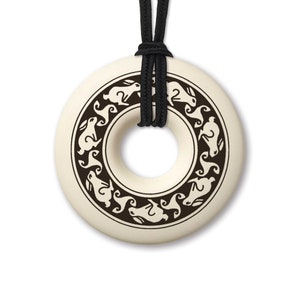 May include: A white ceramic pendant with a black design of rabbits around the edge. The pendant is attached to a black cord.