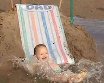 Parent-built, rollable slide Sheet for super slippery toddler fun on sandy Beaches or peg to grass.