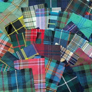 May include: A collection of colourful fabric squares with plaid patterns in various shades of green, blue, red, and yellow. The squares are arranged in a random pattern, creating a patchwork effect.