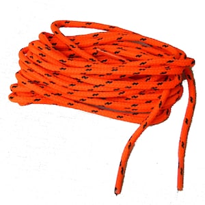 May include: Orange and black shoelaces with a woven design. The shoelaces are coiled and two ends are extended.