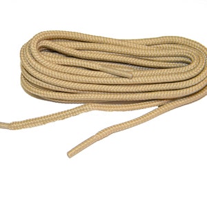 May include: A pair of tan shoelaces, coiled and ready to be used.