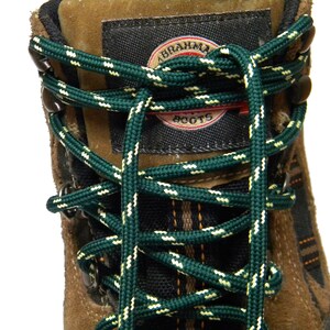May include: Close-up of brown leather hiking boots with green and white laces. The boots have a black label with the text "ABRAHAM BOOTS".