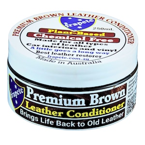 May include: A white jar with a brown lid labelled "Premium Brown Leather Conditioner". The jar is 250 ml and contains a plant-based, chemical-free leather conditioner. The label also states "Made in Australia" and "Brings Life Back to Old Leather".