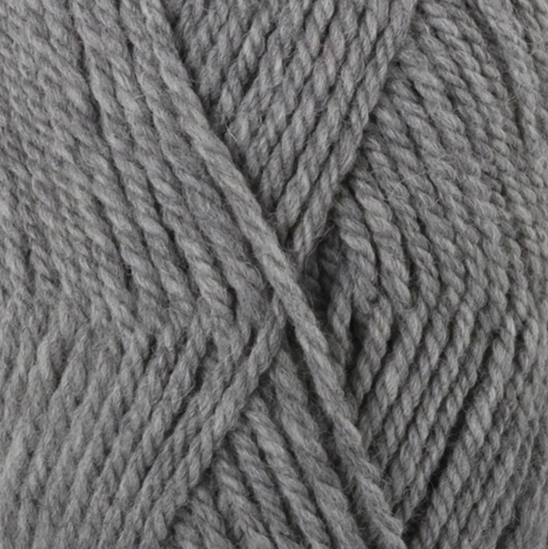 May include: Close-up of gray yarn, showing the texture of the thick, twisted fibers. The yarn appears soft and is a solid, neutral color. The image highlights the individual strands and the overall bulk of the material, suitable for knitting or crocheting projects.