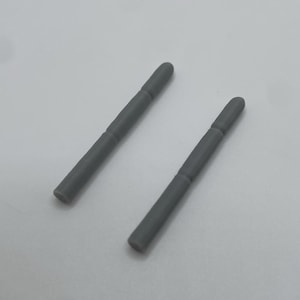 May include: Two gray, cylindrical stylus replacements. Each stylus has a rounded tip and a slightly thicker midsection. The items are set against a plain, light background.