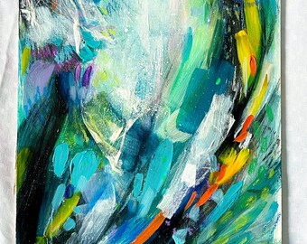 May include: Abstract painting with a white center surrounded by swirling strokes of blue, green, yellow, orange, and black paint.