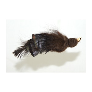 May include: A brown and black feathered bird ornament with a white beak. The ornament is made of fur and feathers.