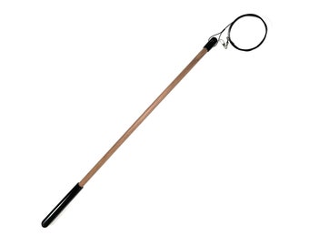 May include: A wooden stick with a black handle and a circular metal loop at the end. The loop is attached to the stick with a black cord.