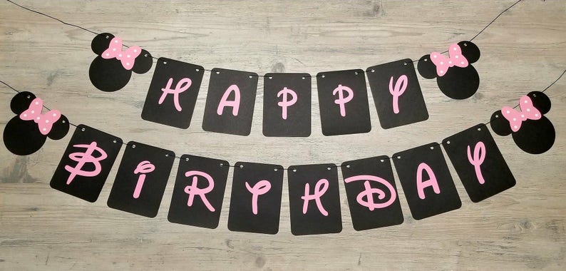 May include: Black and pink banner with the words "Happy Birthday" and two Minnie Mouse heads on either end.