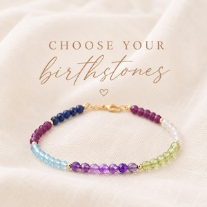 May include: A gold bracelet adorned with an assortment of colourful gemstones. The bracelet showcases blue, purple, green, and clear stones. The text "CHOOSE YOUR birthstones" is written in a cursive font above the bracelet.