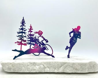 Triathlon, Ironman swim bike run sculpture made of stainless steel and stone. Galaxy figures mounted on Vermont white marble. 12" x 5" x 6"