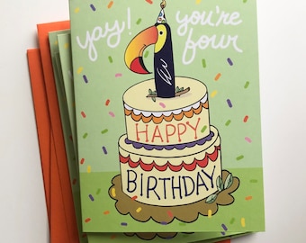 May include: A green birthday card featuring a toucan wearing a party hat perched on top of a cake that reads "Happy Birthday". The card also says "yay! you're four" in white lettering.