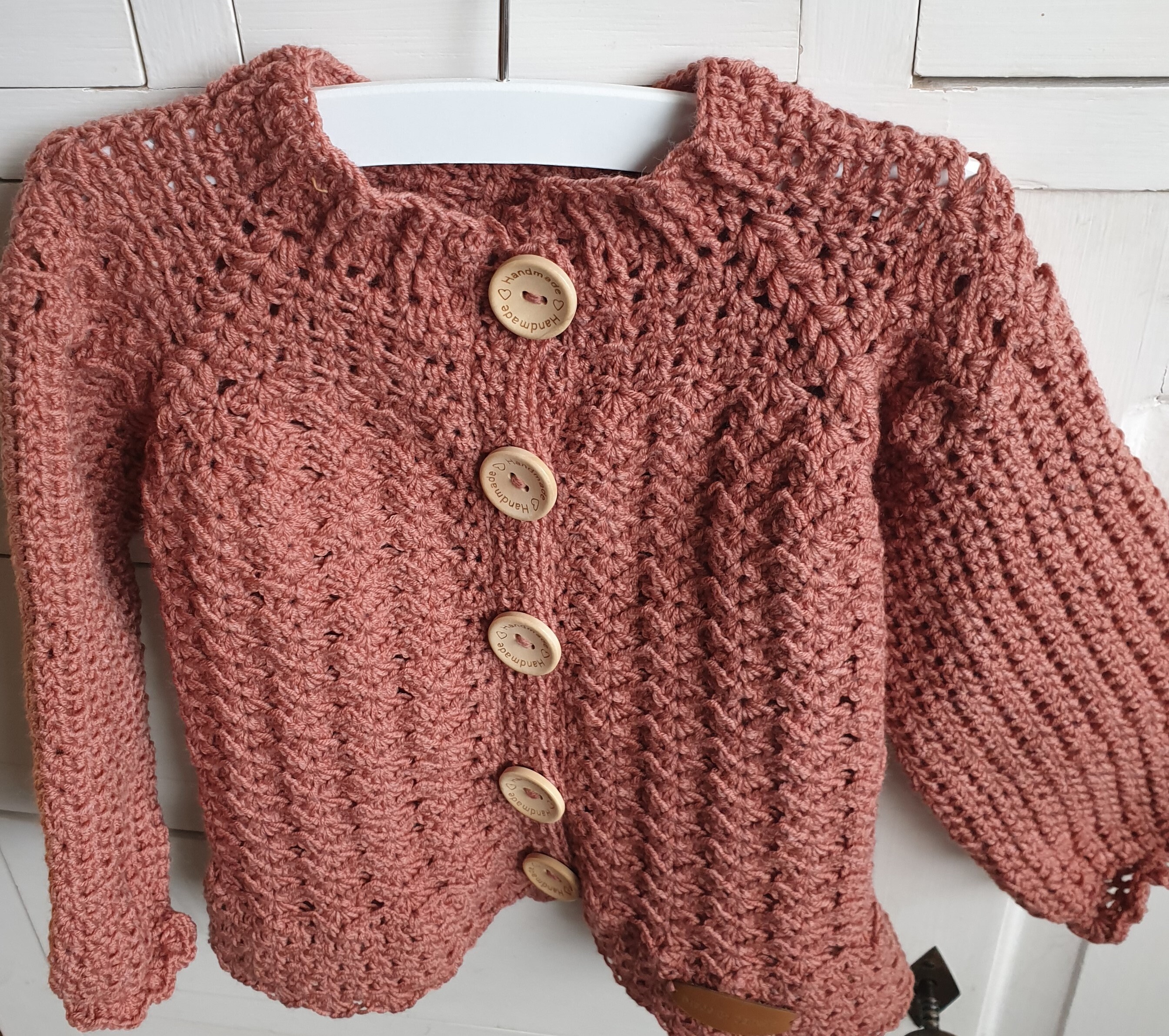 Crocheted toddler vest with fantasy stitch arches.