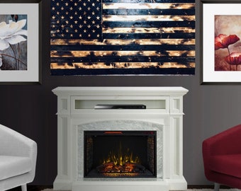 May include: A wooden American flag wall art piece with a distressed, burnt wood effect. The flag features the stars and stripes design, with a dark blue field and gold-toned stars. The stripes have a charred appearance.