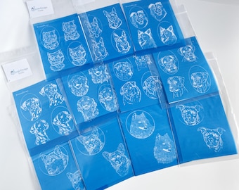 May include: A selection of blue cards with white line drawings of different dog breeds. Each card displays several dog portraits. The cards are packaged in clear plastic sleeves. The text "Personalized Design Tools" is visible on a label.
