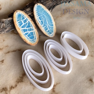 May include: Oval earrings with a blue and white cracked design, and white oval polymer clay cutters. The earrings have a wooden-effect border. The image also shows the text "JESSAMA DESIGN".