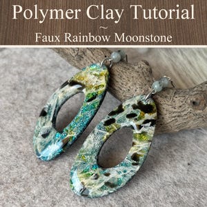 May include: A pair of oval-shaped earrings featuring a faux rainbow moonstone effect in shades of teal, green, and black with a glossy finish. The text Polymer Clay Tutorial Faux Rainbow Moonstone is displayed at the top of the image.