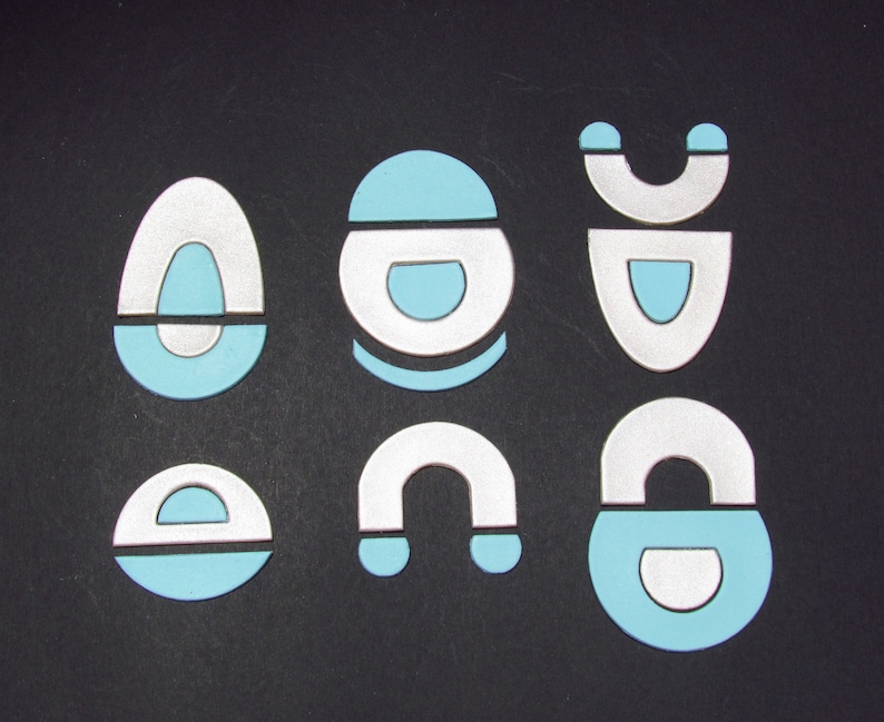 May include: Six different shapes made of white and light blue paper. The shapes are a circle, a teardrop, a crescent moon, a rectangle, a half circle, and a teardrop with a half circle on top.