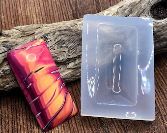 May include: A rectangular silicone mold and a finished rectangular resin piece featuring a vibrant, swirling pattern of bright pink, orange, and deep purple colors. The resin piece has a smooth, glossy finish with distinct color transitions.