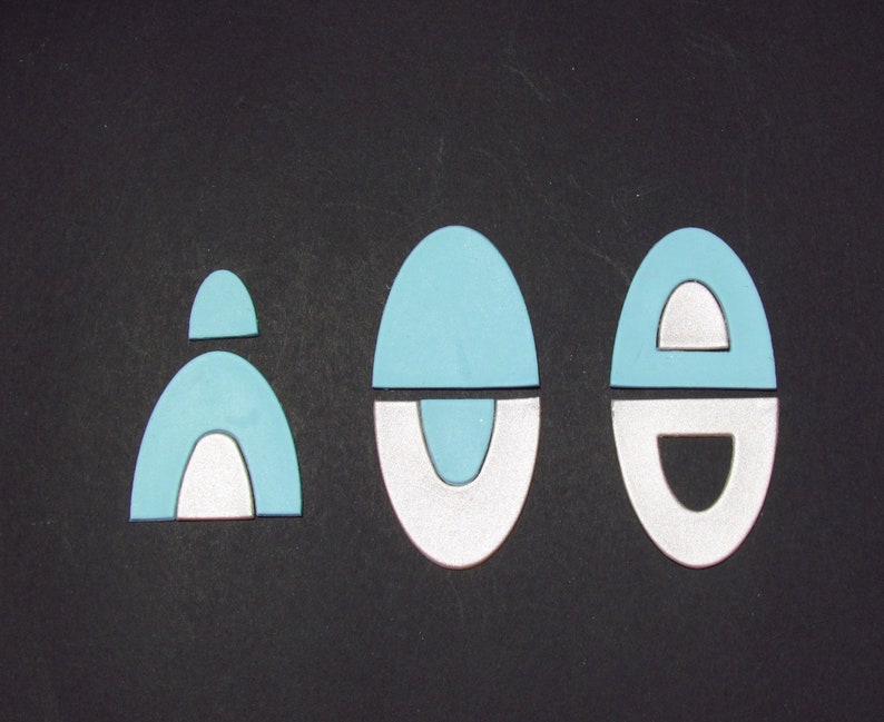 May include: Three blue and white geometric shapes on a black background. The shapes are all different sizes and have a variety of curves and lines.